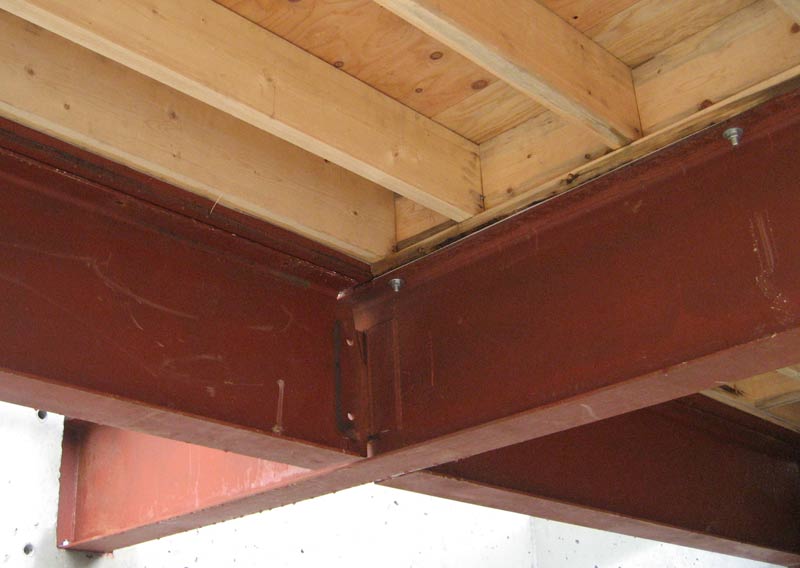 welded-steel-beams-with-top-plate-conncted-with-bolts-and-floor-joists-above