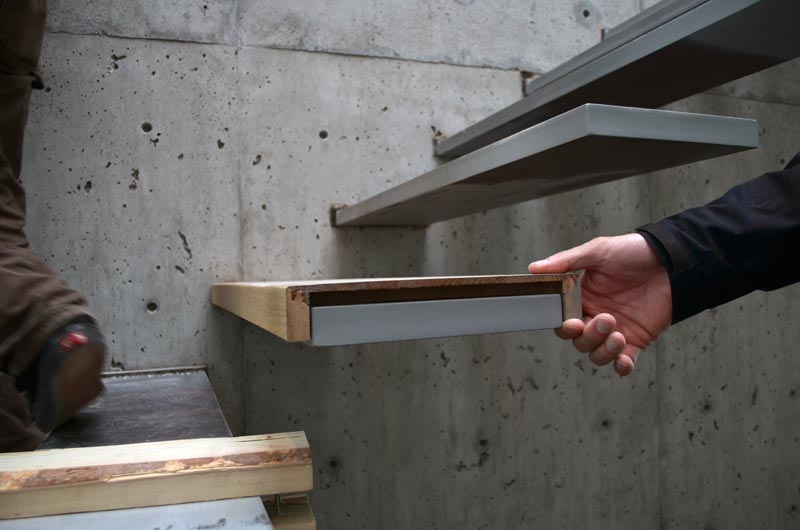 STEEL-CANTILEVERED-STEPS-ATTACHED-TO-CONCRETE-WALL-WOOD-SURFACE-FINISH